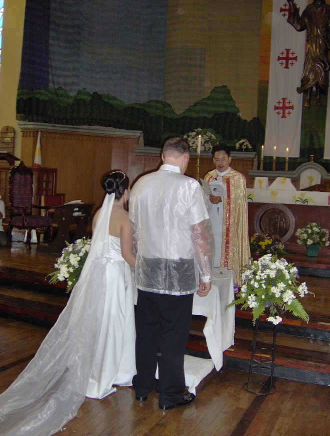 Joy and Jon at the alter.  Take note of the Phillipine wedding shirt for men. Alex wore one also.